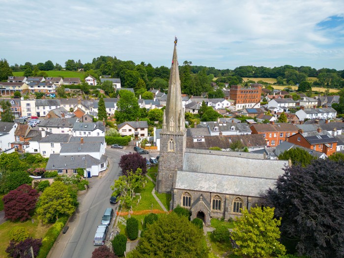 1404647766 UFFCULME, ENGLAND - JUNE 23: Arthur Needham from Vitruvius Building Conservation paints the lightning conductor on the steeple as part of restoration work at the top of St Mary’s Church, on June 23, 2022 in Uffculme, United Kingdom. (Photo by Finnbarr Webster/Getty Images)
