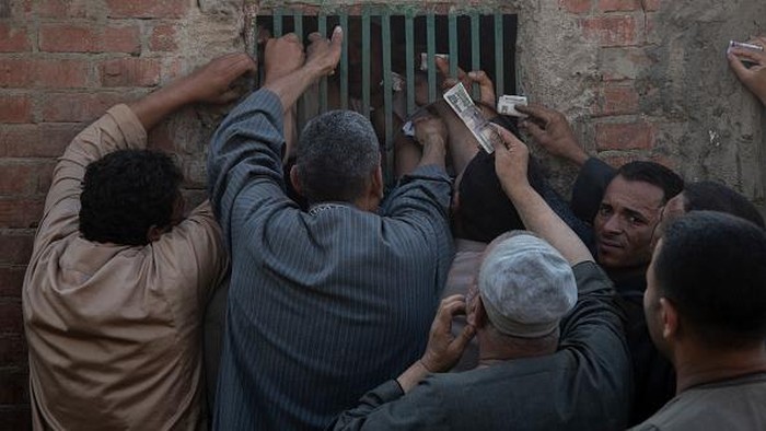 Cattle traders and customers crowd at livestock 