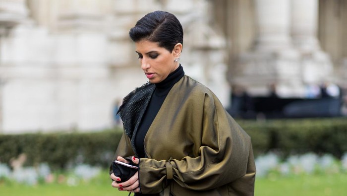 PARIS, FRANCE - MARCH 07: Deena Aljuhani Abdulaziz wearing wide leg pants and coat outside Chanel on March 7, 2017 in Paris, France. (Photo by Christian Vierig/Getty Images)