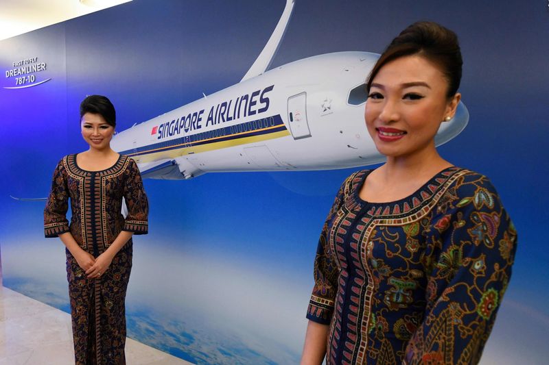 Seragam Pramugari Singapore Airlines A Singapore Airlines stewardess poses along the aisle during a media tour onboard a Singapore Airlines Airbus A380 at Changi International Airport in Singapore on October 24, 2020. (Photo by ROSLAN RAHMAN / AFP) (Photo by ROSLAN RAHMAN/AFP via Getty Images)