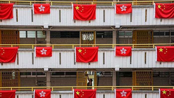 Rows of Chinese and Hong Kong flags decorate a residential building, ahead of the 25th anniversary of Hong Kongs handover to China from Britain, in Hong Kong, China June 26, 2022. REUTERS/Lam Yik