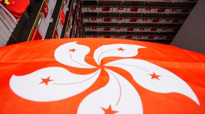 Rows of Chinese and Hong Kong flags decorate a residential building, ahead of the 25th anniversary of Hong Kongs handover to China from Britain, in Hong Kong, China June 26, 2022. REUTERS/Lam Yik