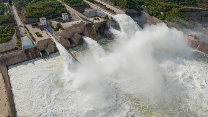 LUOYANG, CHINA - JUNE 25: People watch water gushing out from the Xiaolangdi Reservoir on the Yellow River during a water and sediment regulating operation on June 25, 2022 in Luoyang, Henan Province of China. (Photo by Huang Zhengwei/VCG via Getty Images)
