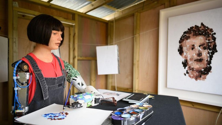 GLASTONBURY, ENGLAND - JUNE 23: Ai-DA, the worlds first robot artist, paints portraits of the headline acts, including Kendrick Lamar, in the Ai-DA Robot Booth in the Shangri La Field, during day two of Glastonbury Festival at Worthy Farm, Pilton on June 23, 2022 in Glastonbury, England. (Photo by Leon Neal/Getty Images)