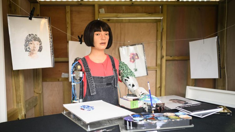 GLASTONBURY, ENGLAND - JUNE 23: Ai-DA, the worlds first robot artist, paints portraits of the headline acts, including Kendrick Lamar, in the Ai-DA Robot Booth in the Shangri La Field, during day two of Glastonbury Festival at Worthy Farm, Pilton on June 23, 2022 in Glastonbury, England. (Photo by Leon Neal/Getty Images)