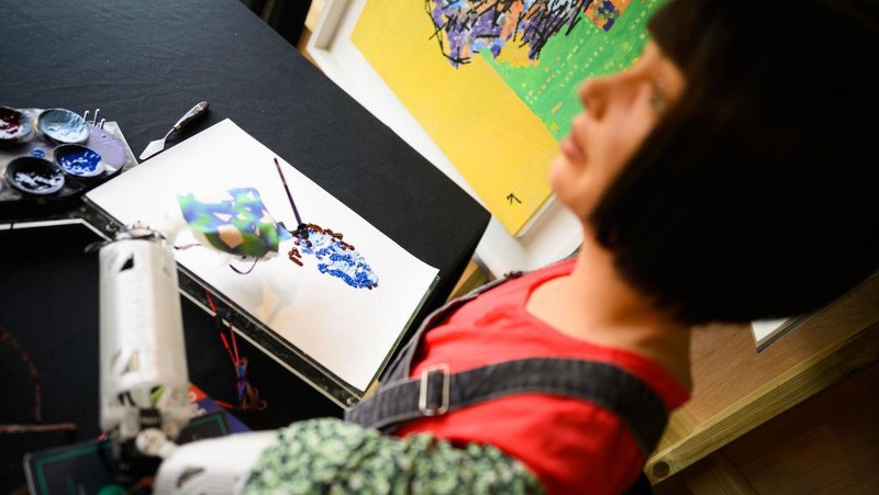 GLASTONBURY, ENGLAND - JUNE 23: Ai-DA, the world's first robot artist, paints portraits of the headline acts, including Kendrick Lamar, in the Ai-DA Robot Booth in the Shangri La Field, during day two of Glastonbury Festival at Worthy Farm, Pilton on June 23, 2022 in Glastonbury, England. (Photo by Leon Neal/Getty Images)