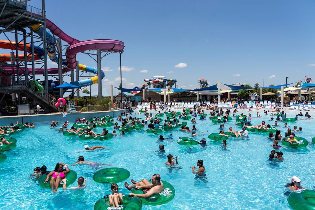 Employees dump ice from wheelbarrows into the pool at the Typhoon Texas Waterpark in Katy, Texas, U.S. June 26, 2022.  REUTERS/Go Nakamura     TPX IMAGES OF THE DAY