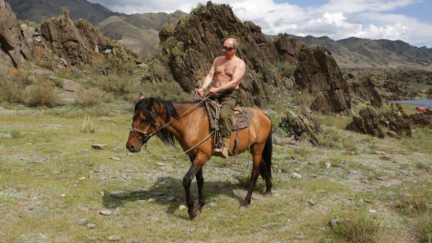In this photo taken on Monday, Aug. 3, 2009, Russian Prime Minister Vladimir Putin seen riding a horse in the mountains of the Siberian Tyva region (also referred to as Tuva),  Russia, during his short vacation. (AP Photo/ RIA Novosti, Alexei Drizhinin, Pool)