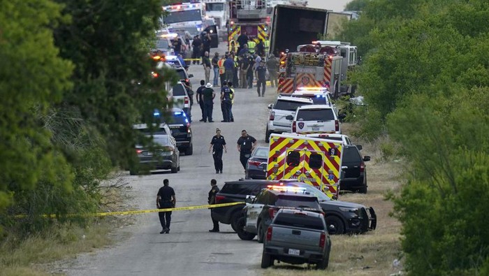 Police work the scene where dozens of people were found dead in a semitrailer in a remote area in southwestern San Antonio, Monday, June 27, 2022. (AP Photo/Eric Gay)