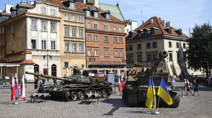 People visit an open-air exhibition of damaged and burnt-out Russian tanks and armored vehicles at the Castle Square, in Warsaw, Poland, Monday, June 27, 2022. The vehicles were captured by Ukrainian military forces during the war in the Ukraine. Ukrainian authorities announced that there are plans for similar exhibits in other European capitals such as Berlin, Paris, Madrid and Lisbon. (AP Photo/Michal Dyjuk)