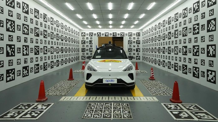 A self-driving taxi developed by tech giant Baidu Inc. is seen in a chamber used to calibrate its sensors, on June 14, 2022, in Beijing. Baidu Inc. is China's highest-profile competitor in a multibillion-dollar race with Alphabet Inc.'s Waymo and General Motors Co.'s Cruise to create self-driving cars. (AP Photo/Ng Han Guan)