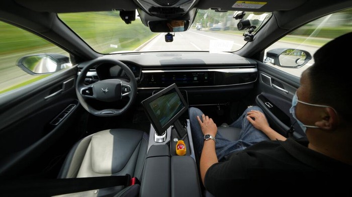 A self-driving taxi developed by tech giant Baidu Inc. is seen in a chamber used to calibrate its sensors, on June 14, 2022, in Beijing. Baidu Inc. is China's highest-profile competitor in a multibillion-dollar race with Alphabet Inc.'s Waymo and General Motors Co.'s Cruise to create self-driving cars. (AP Photo/Ng Han Guan)