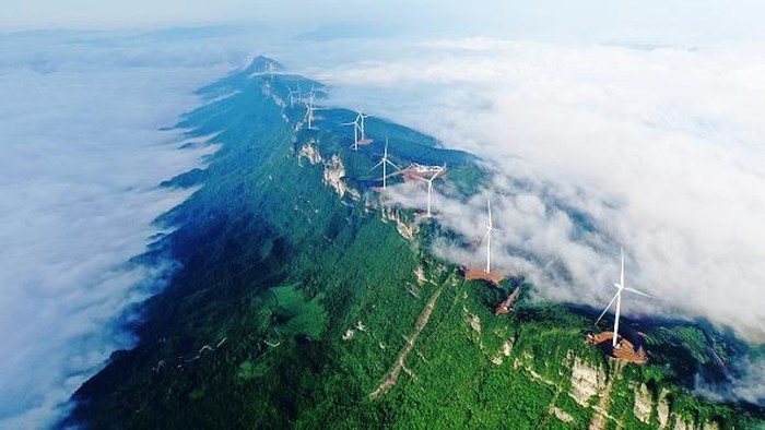 CHONGQING, CHINA - JUNE 28, 2022 - Clouds wrap around the Wufuling Wind Farm in Chongqing, Southwest China, June 28, 2022. (Photo credit should read CFOTO/Future Publishing via Getty Images)