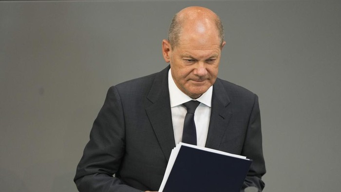 German Chancellor Olaf Scholz leaves the podium after his speech at the German parliament Bundestag at the Reichstag building in Berlin, Germany, Wednesday, June 22, 2022. (AP Photo/Markus Schreiber)