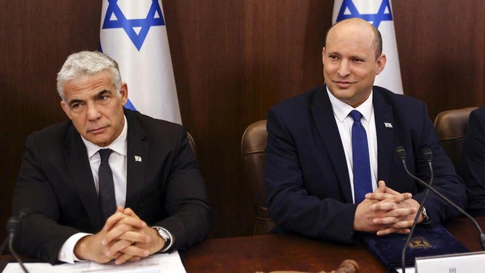 Israeli Prime Minister Naftali Bennett is expected to hand over power to Foreign Minister Yair Lapid after parliament dissolves itself RONEN ZVULUN POOL/AFP