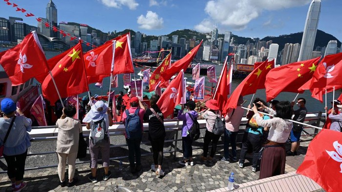 A fishing boat with banners and flags to mark the 25th anniversary of the Handover of Hong Kong from Britain to China is moored in Hong Kongs Victoria harbour on June 28, 2022. The Handover anniversary falls on July 1. (Photo by Peter PARKS / AFP) (Photo by PETER PARKS/AFP via Getty Images)