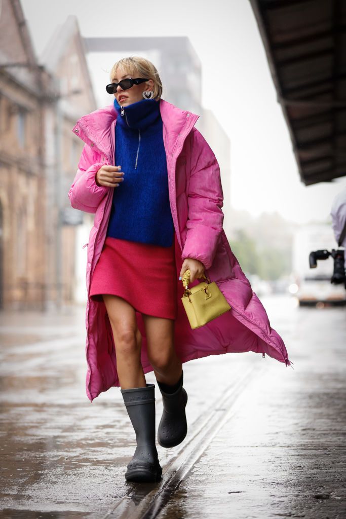 SYDNEY, AUSTRALIA - MAY 12: Violet Grace Atkinson wearing Ganni coat, Ganni skirt, Balenciaga boots, Louis Vuitton bag, Cos jumper and Prada glasses at Afterpay Australian Fashion Week 2022 on May 12, 2022 in Sydney, Australia. (Photo by Hanna Lassen/Getty Images)