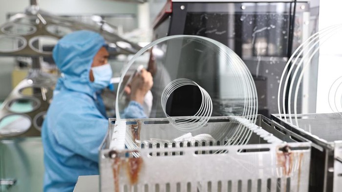 RUGAO, CHINA - JUNE 23: Workers assemble astronomical telescope lens at the workshop of Nantong Schmidt Opto Electrical Co., Ltd. on June 23, 2022 in Rugao, Jiangsu Province of China. (Photo by Qiu Yu/VCG via Getty Images)