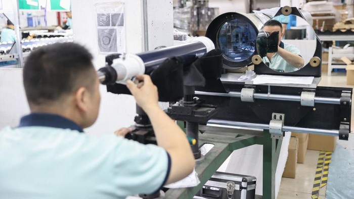 RUGAO, CHINA - JUNE 23: Workers assemble astronomical telescope lens at the workshop of Nantong Schmidt Opto Electrical Co., Ltd. on June 23, 2022 in Rugao, Jiangsu Province of China. (Photo by Qiu Yu/VCG via Getty Images)