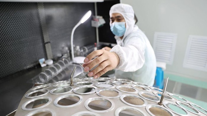 RUGAO, CHINA - JUNE 23: Workers assemble astronomical telescope lens at the workshop of Nantong Schmidt Opto Electrical Co., Ltd. on June 23, 2022 in Rugao, Jiangsu Province of China. (Photo by Qiu Yu/VCG via Getty Images)