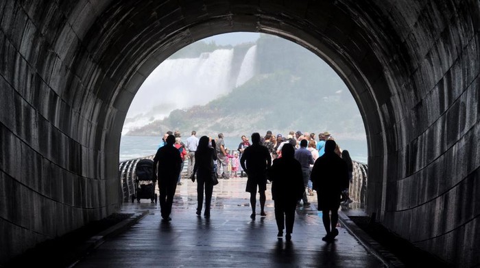 1405961118 ONTARIO, CANADA - JUNE 29: Tourists step onto a viewing platform to enjoy the view of Niagara Falls on June 29, 2022 in Ontario, Canada. Tourists can walk through the tunnel deep below the Niagara Parks Power Station and then step out onto a viewing platform to enjoy the view of Niagara Falls. (Photo by Yu Ruidong/China News Service via Getty Images)