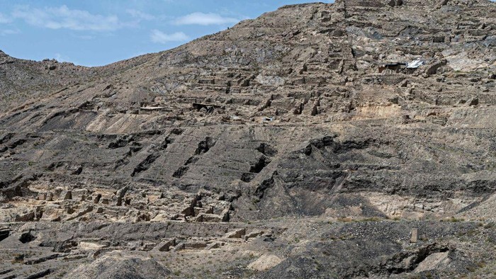 In this photograph taken on May 17, 2022, historical monuments department manager Jalat Surkhabi shows a structure uncovered at an archaeological site in Mes Aynak, in the eastern province of Logar. - An ancient Buddhist city carved out of immense peaks near Kabul is in danger of disappearing forever, swallowed up by a Chinese consortium exploiting one of the world's largest copper deposits. Located at the confluence of Hellenistic and Indian cultures, Mes Aynak -- believed to be between 1,000 and 2,000 years old -- was once a vast city organised around the extraction and trade of copper. - TO GO WITH 'Afghanistan-China-minig-Buddhism' (Photo by Wakil KOHSAR / AFP) / TO GO WITH 'Afghanistan-China-minig-Buddhism' (Photo by WAKIL KOHSAR/AFP via Getty Images)