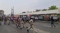 Dalam foto yang diambil dari rekaman video, polisi mencoba mengendalikan kerumunan yang meneriakkan slogan-slogan selama protes setelah pembunuhan seorang penjahit. Pria Hindu, Kanhaiya Lal, ditikam beberapa kali di dalam toko jahitnya pada hari Selasa oleh dua pria pemegang golok yang juga merekam serangan itu lalu membagikannya di media sosial.