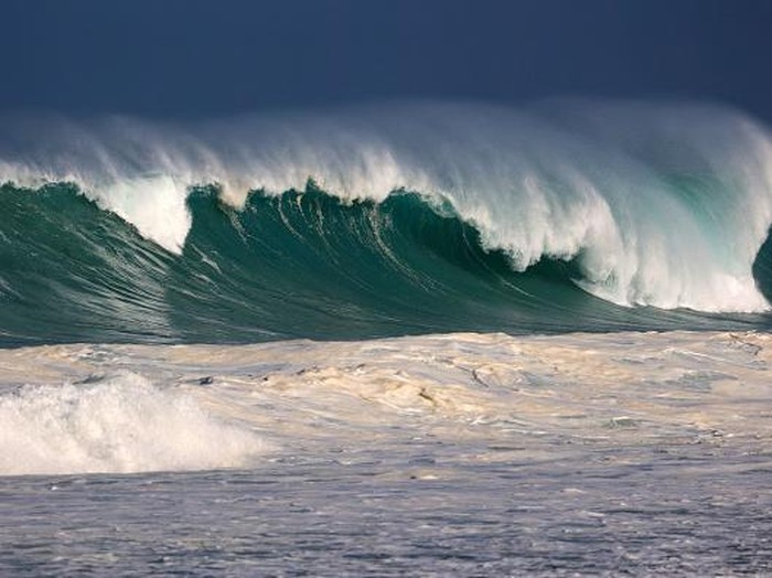 Residents watch the waves during a breaking swell in Saint-Leu, in the south of the French island of Reunion, Indian Ocean, on June 29, 2022, after a wave-submergence alert was declared. (Photo by Richard BOUHET / AFP) (Photo by RICHARD BOUHET/AFP via Getty Images)