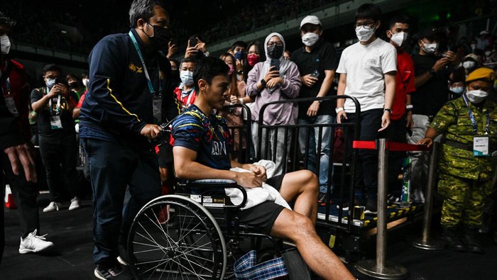 Japan's Kento Momota (2nd L) gestures as he leaves the court after his opponent Indonesia's Rhustavito Shesar Hiren (R) retired due an injury during their mens singles quarter-final match at the Malaysia Open badminton tournament in Kuala Lumpur on July 1, 2022. (Photo by Mohd RASFAN / AFP) (Photo by MOHD RASFAN/AFP via Getty Images)