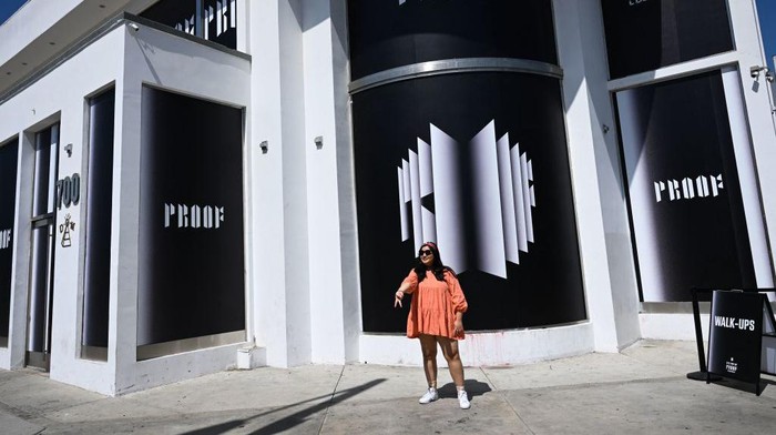 A K-pop fan poses for a picture outside as they visit a BTS pop-up store to promote the album 'Proof' in Los Angeles, California on June 15, 2022. - K-pop supergroup BTS announced June 14, 2022 they were taking an indefinite break from one of the world's most popular acts to focus on solo (Photo by Patrick T. FALLON / AFP) (Photo by PATRICK T. FALLON/AFP via Getty Images)