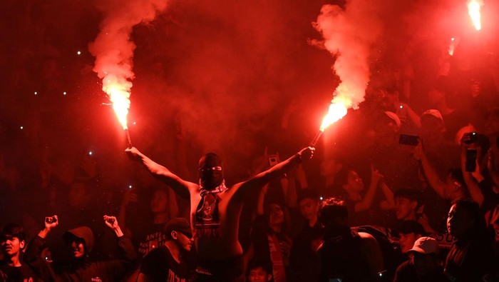 Suporter Tim Nasional Indonesia U-19 menyalakan suar (flare) saat melawan Tim Nasional Vietnam U-19 dalam laga penyisihan Grup A Piala AFF U-19 2022 di Stadion Patriot Candrabhaga, Bekasi, Jawa Barat, Sabtu (2/7/2022). Skor pertandingan berakhir seri 0-0. ANTARA FOTO/Aditya Pradana Putra/rwa.