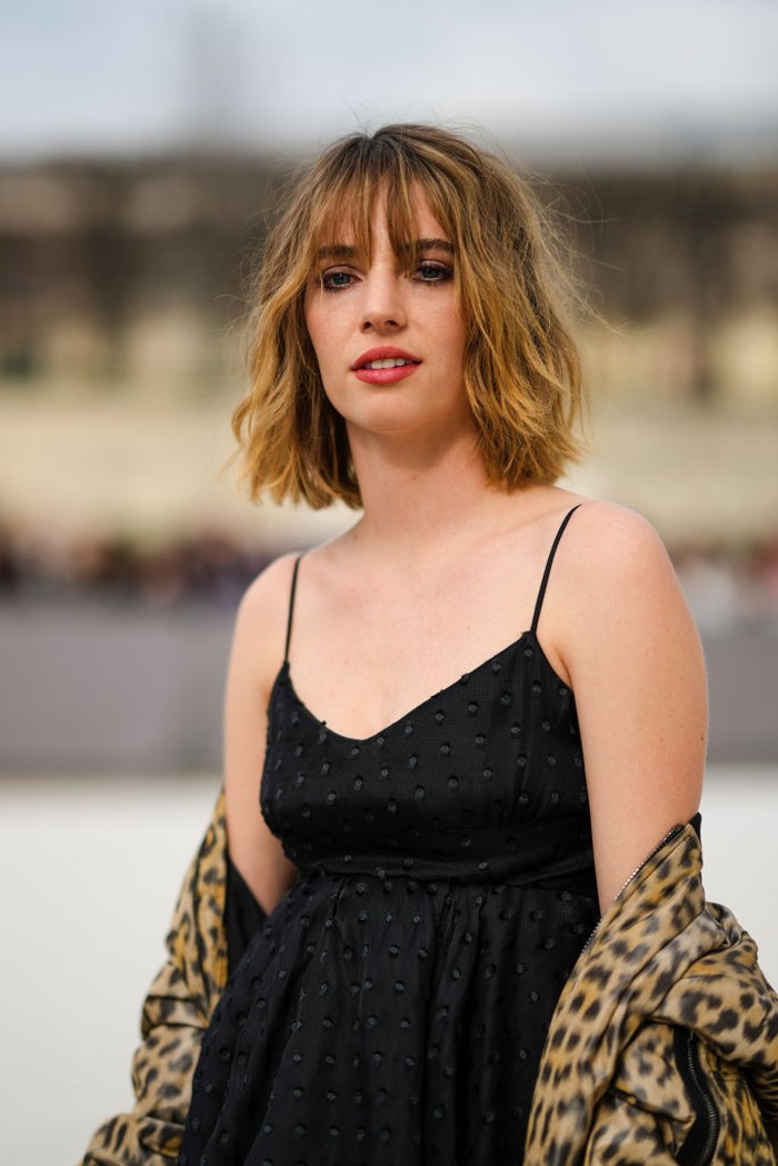 PARIS, FRANCE - MARCH 01: Maya Thurman-Hawke wears a black tulle with polka dots print pattern ruffled short dress, a beige with brown and black leopard print pattern zipper oversized bomber coat, outside Dior, during Paris Fashion Week - Womenswear F/W 2022-2023, on March 01, 2022 in Paris, France. (Photo by Edward Berthelot/Getty Images)