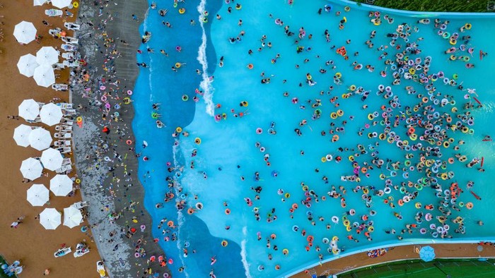 1406668506 HUAI'AN, CHINA - JULY 03: Aerial view of tourists enjoying themselves at a water park on a summer day on July 3, 2022 in Huai'an, Jiangsu Province of China. (Photo by VCG/VCG via Getty Images)