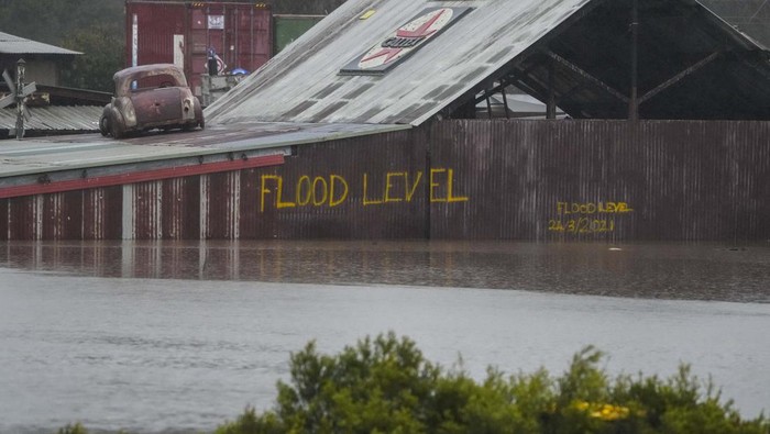A car blocks access to a flooded street at Camden on the outskirts of Sydney, Australia, Monday, July 4, 2022. More than 30,000 residents of Sydney and its surrounds have been told to evacuate or prepare to abandon their homes on Monday as Australia’s largest city braces for what could be its worst flooding in 18 months. (AP Photo/Mark Baker)