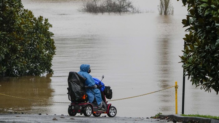 A car blocks access to a flooded street at Camden on the outskirts of Sydney, Australia, Monday, July 4, 2022. More than 30,000 residents of Sydney and its surrounds have been told to evacuate or prepare to abandon their homes on Monday as Australia’s largest city braces for what could be its worst flooding in 18 months. (AP Photo/Mark Baker)