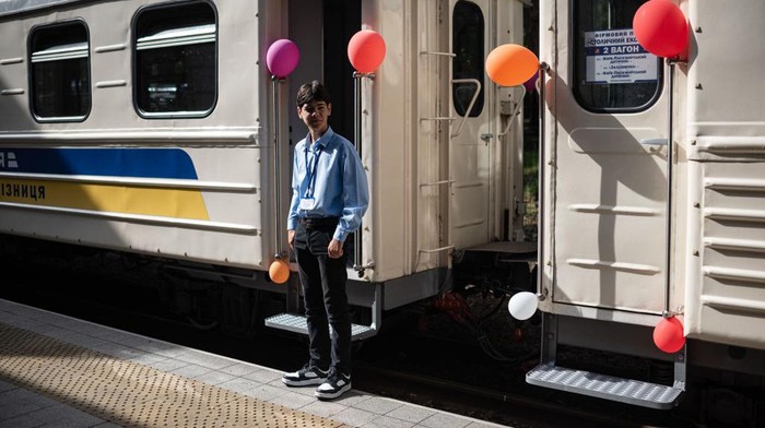KYIV, UKRAINE - JULY 03: Young conductors and one of their mentors pose for a portrait during the steam locomotive presentation at the Kyiv Children's Railway Station on July 3, 2022 in Kyiv, Ukraine. According to the railway's operators, the Gr-336 locomotive was built in Germany in 1951 and brought to Kyiv as part of reparations in the wake of World War II. (Photo by Alexey Furman/Getty Images