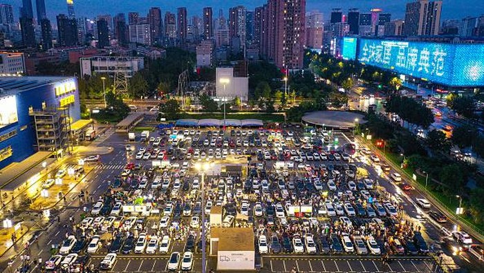 SHENYANG, CHINA - JULY 02: People use the trunks of their cars to sell commodities at a car trunk market on July 2, 2022 in Shenyang, Liaoning Province of China. (Photo by VCG/VCG via Getty Images)