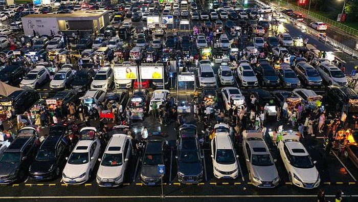 SHENYANG, CHINA - JULY 02: People use the trunks of their cars to sell commodities at a car trunk market on July 2, 2022 in Shenyang, Liaoning Province of China. (Photo by VCG/VCG via Getty Images)