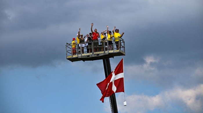 Lihat Lagi Antusiasme Denmark Saat Dilintasi Pebalap Tour de France Spectators cheer atop a cherry picker adorned with a Danish flag, along the stage route of the 3rd stage of the 109th edition of the Tour de France cycling race, 182 km between Vejle and Sonderborg in Denmark, on July 3, 2022. (Photo by Anne-Christine POUJOULAT / AFP) (Photo by ANNE-CHRISTINE POUJOULAT/AFP via Getty Images)