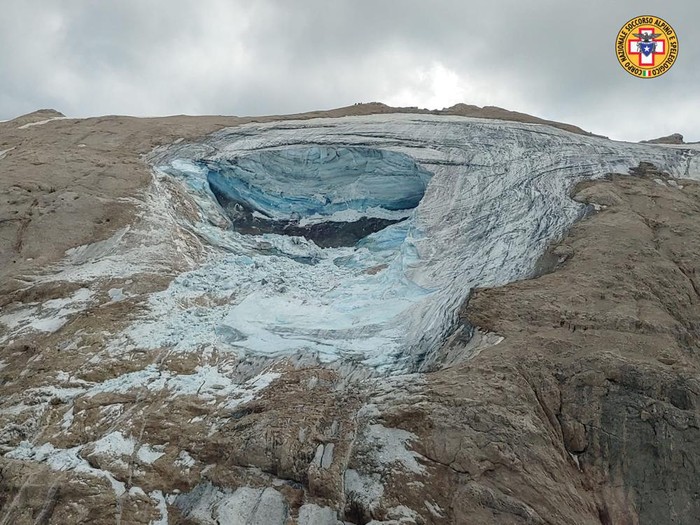 This image released on Sunday, July 3, 2022, by the Italian National Alpine and Cave Rescue Corps shows the glacier in Italys Alps near Trento a large chunk of which has broken loose, killing at least six hikers and injuring eight others. Alpine rescue service officials, which provided that toll Sunday evening, said it could take hours to determine if any hikers might be missing. The National Alpine and Cave Rescue Corps tweeted that the search of the involved area of Marmolada peak involved at least five helicopters and rescue dogs. (Corpo Nazionale Soccorso Alpino e Speleologico via AP)