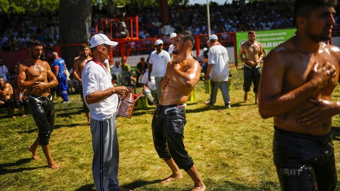 Wrestlers compete during the 661st annual Historic Kirkpinar Oil Wrestling championship, in Edirne, northwestern Turkey, Sunday, July 3, 2022. The festival is part of UNESCO's List of Intangible Cultural Heritages. (AP Photo/Francisco Seco)