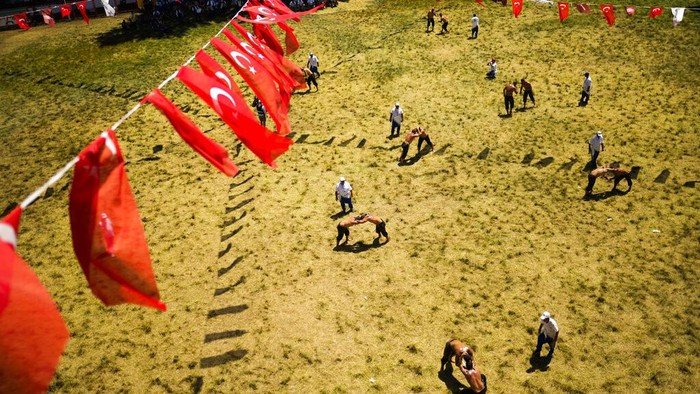 Wrestlers compete during the 661st annual Historic Kirkpinar Oil Wrestling championship, in Edirne, northwestern Turkey, Sunday, July 3, 2022. The festival is part of UNESCO's List of Intangible Cultural Heritages. (AP Photo/Francisco Seco)