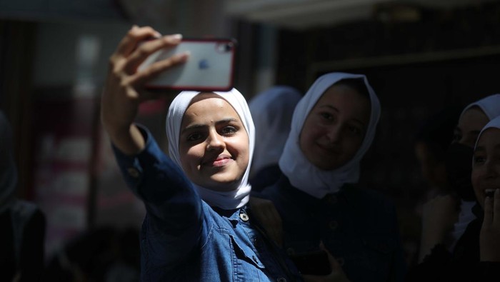 Palestinian students celebrate the last day in their final high school exams, known as ''Tawjihi'', in Gaza city on July 04, 2022.  (Photo by Majdi Fathi/NurPhoto via Getty Images)