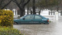 Pada Senin (4/7) waktu setempat, air sungai berwarna cokelat lumpur mengubah daratan yang luas menjadi danau di Camden, pinggiran barat daya Sydney. AP Photo/Mark Baker.