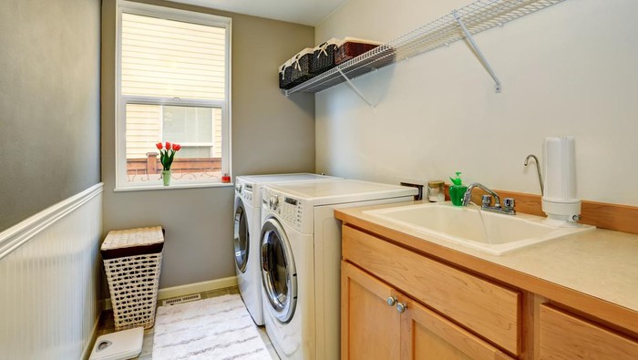 Laundry room with wood cabinets and tile floor. Northwest, USA