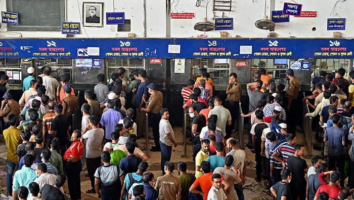 People crowd to buy advance train tickets at a railway station ahead of the Muslim festival of Eid al-Adha, in Dhaka on July 5, 2022. (Photo by Munir UZ ZAMAN / AFP) (Photo by MUNIR UZ ZAMAN/AFP via Getty Images)