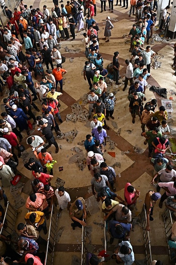 People crowd to buy advance train tickets at a railway station ahead of the Muslim festival of Eid al-Adha, in Dhaka on July 5, 2022. (Photo by Munir UZ ZAMAN / AFP) (Photo by MUNIR UZ ZAMAN/AFP via Getty Images)