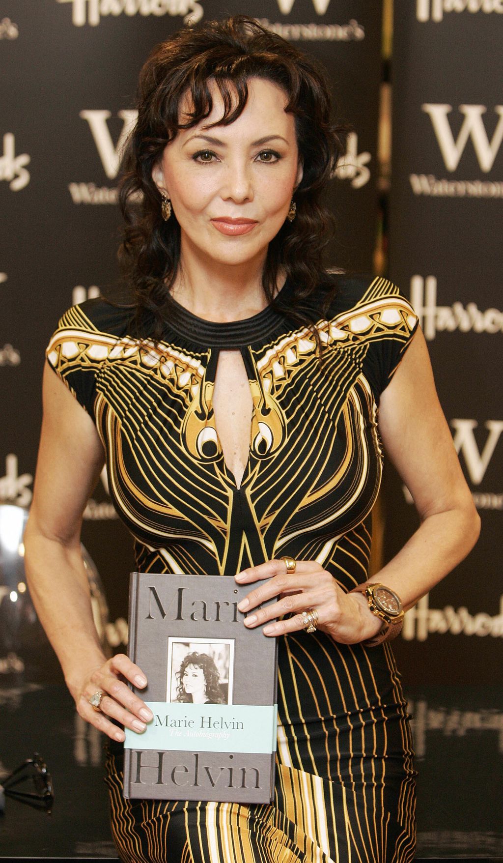 Supermodel and international fashion icon, Marie Helvin, poses with her new book at a photo call at London's Harrods department store 28 September 2007. Her book 