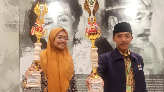 Juara I Tahfidz 5 Juz + Tilawah Putri MTQ XXIX Provinsi Bali Tahun 2022, Safir Lailyah dan Juara I Tilawah Remaja Putra MTQ XXIX Provinsi Bali Tahun 2022, Ivan Jamalullail ketika berpose sembari menunjukkan pialanya pada Senin (4/7/2022) di Gedung Dharma Negara Alaya Denpasar