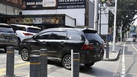 Tidak hanya sepeda motor, mobil juga mengambil lahan trotoar untuk parkir.